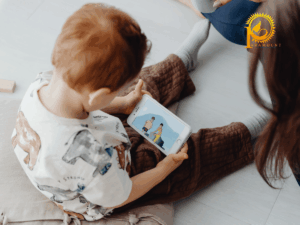 Toddler looking at a mobile phone at mealtime, a common cause of reduced talk time