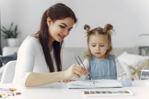 Therapist playing with a young child during a child development assessment at Paramount CDC